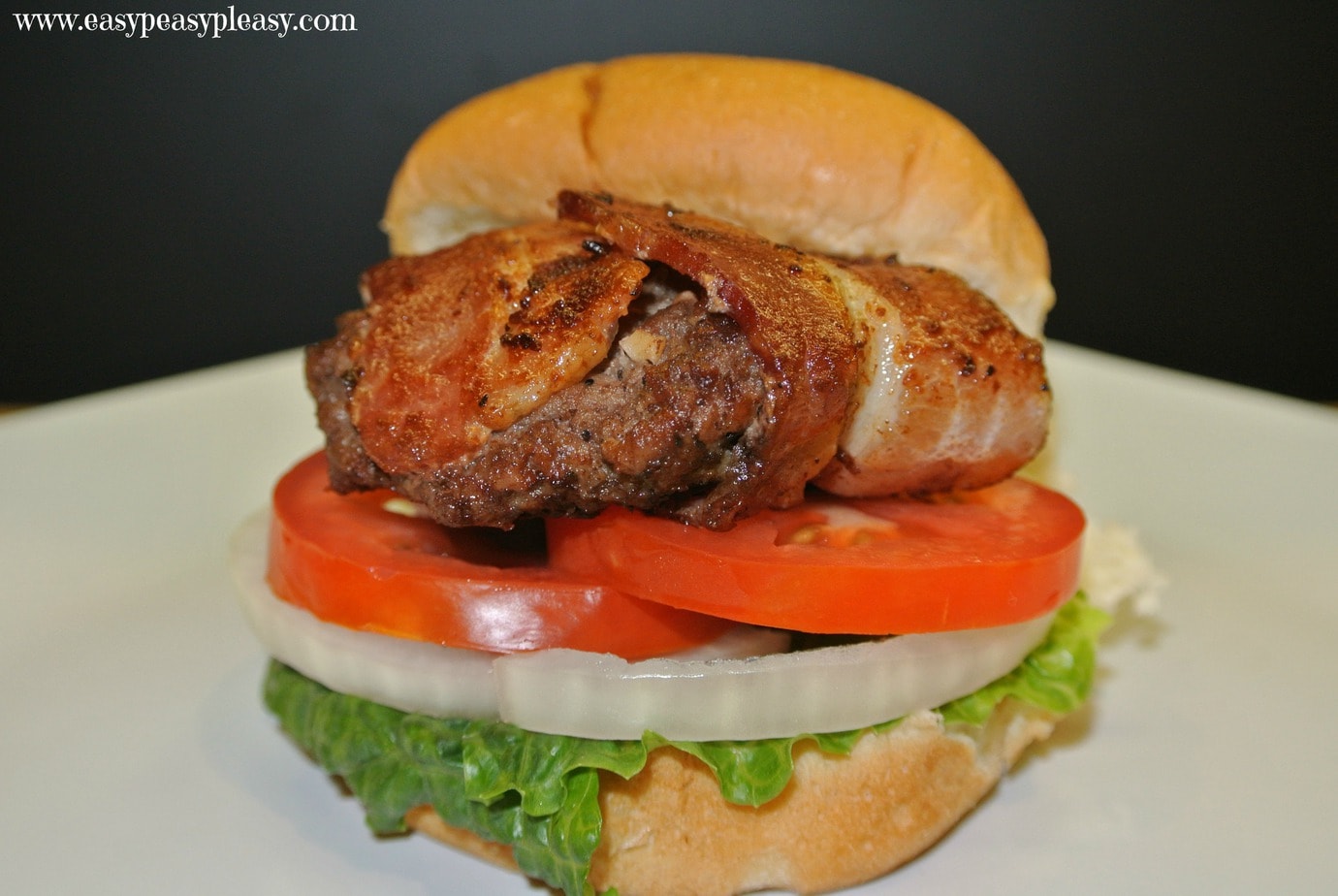 It's cookout season so spare the oven and fire up the grill with these bacon wrapped sliders. There's no need to cook the bacon ahead of time. The bacon cooks on the burger!