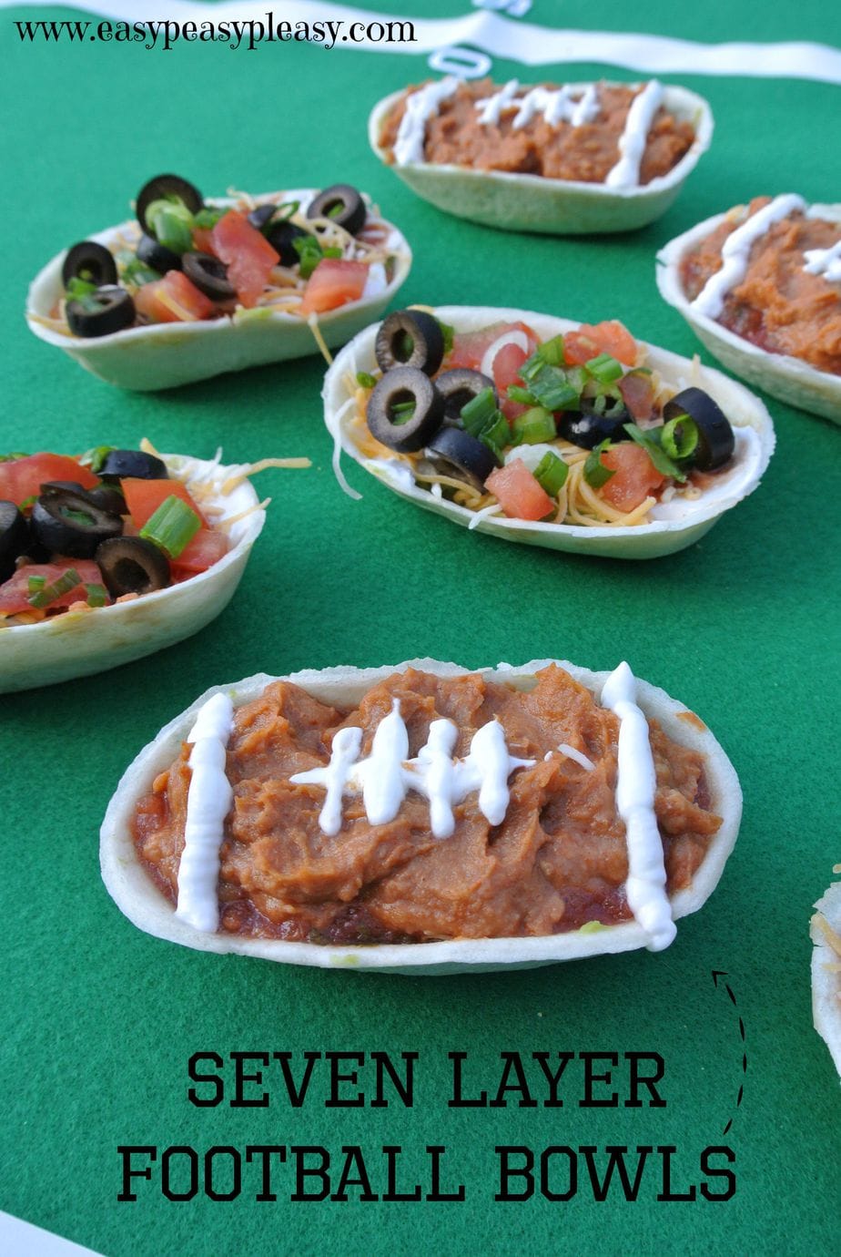 Seven Layer Dip is the perfect appetizer for your next football party. Check out how to make these football bowls.