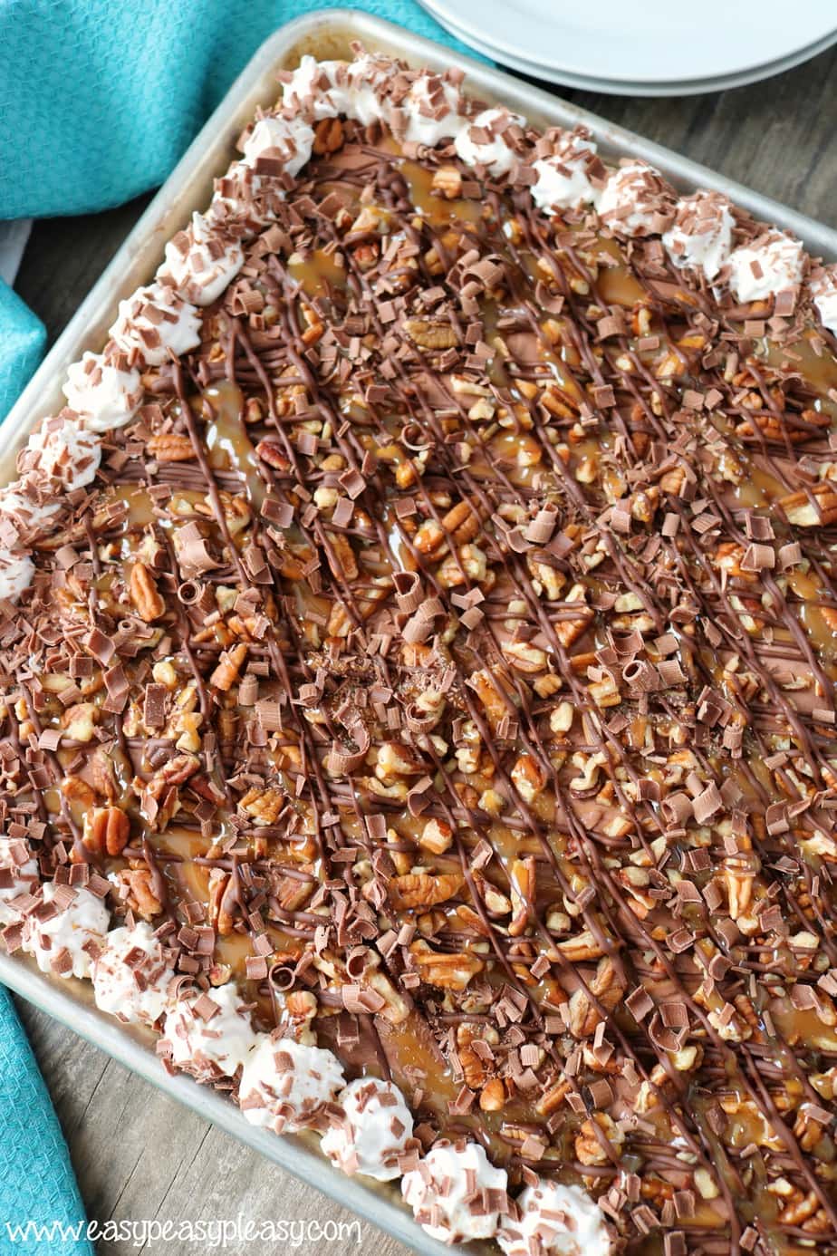 This Chocolate Turtle Slab Pie recipe is the perfect dessert to feed a crowd.