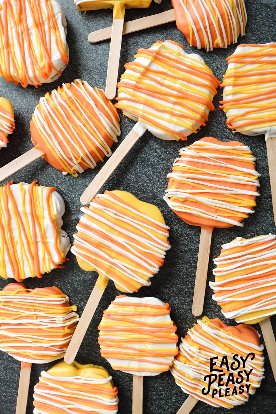 Super easy 2 Ingredient Candy Apple Slices on a stick that has the look of candy corn perfect for Halloween.